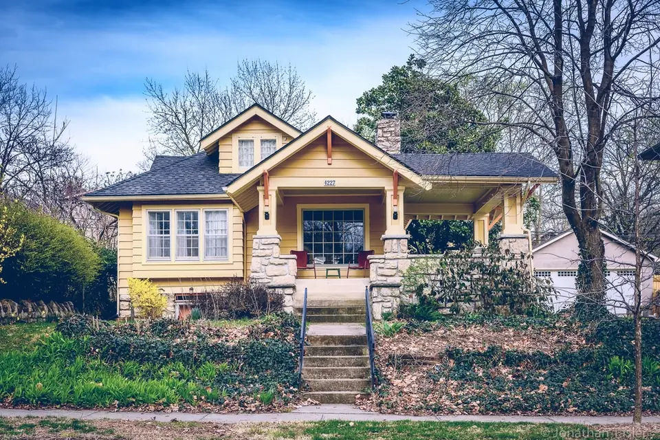A brick and timber house with a front garden